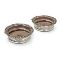 A pair of George IV silver wine coasters, Sheffield, 1821, S.C. Younge & Co., Designed with lobed...