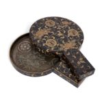 A Japanese bronze hand mirror in painted lacquer case, Meiji period, The mirror cast with trees i...