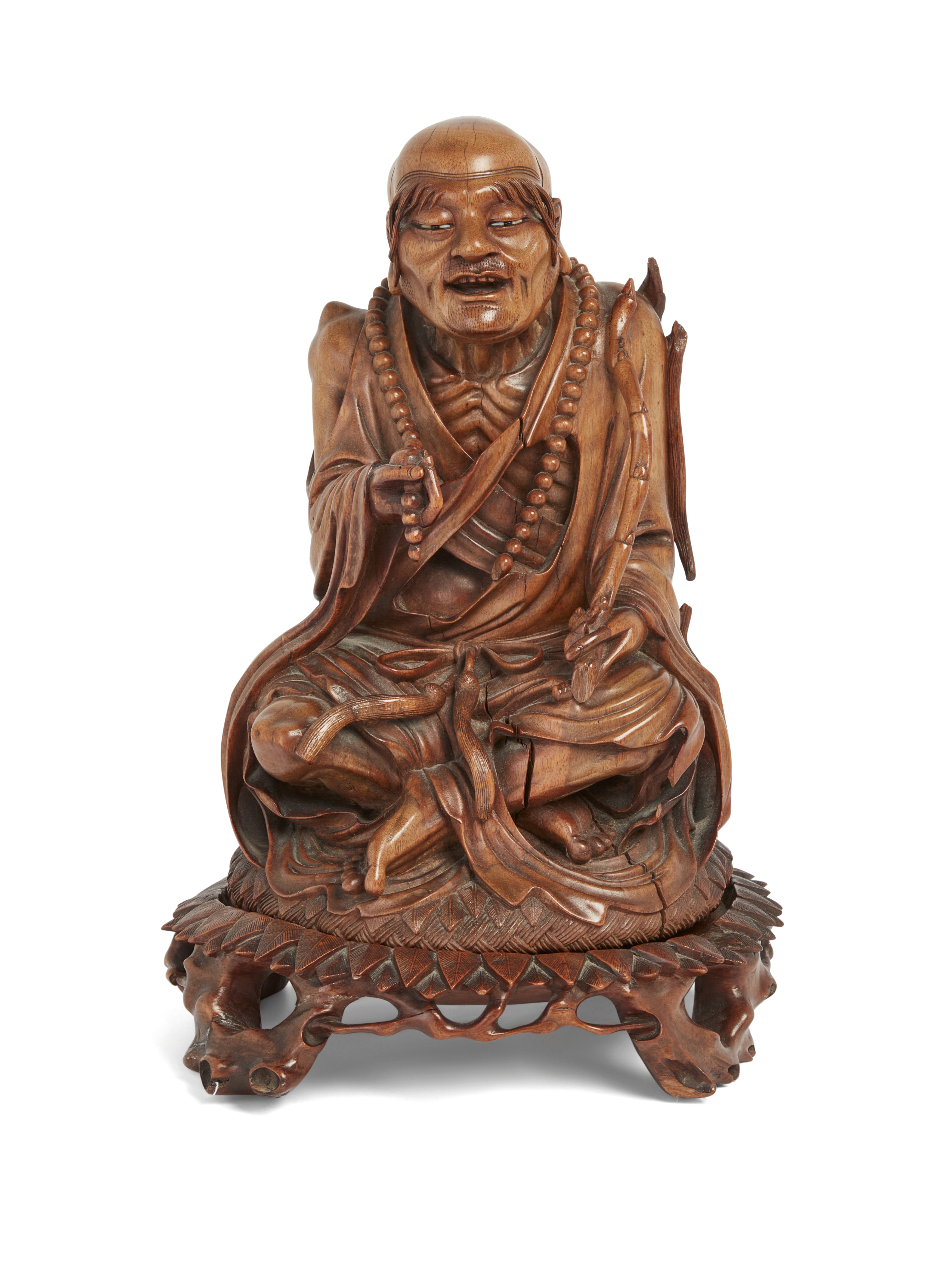 A Chinese hardwood carving of an emaciated Buddhist monk, Late Qing dynasty, Carved with a rosary...