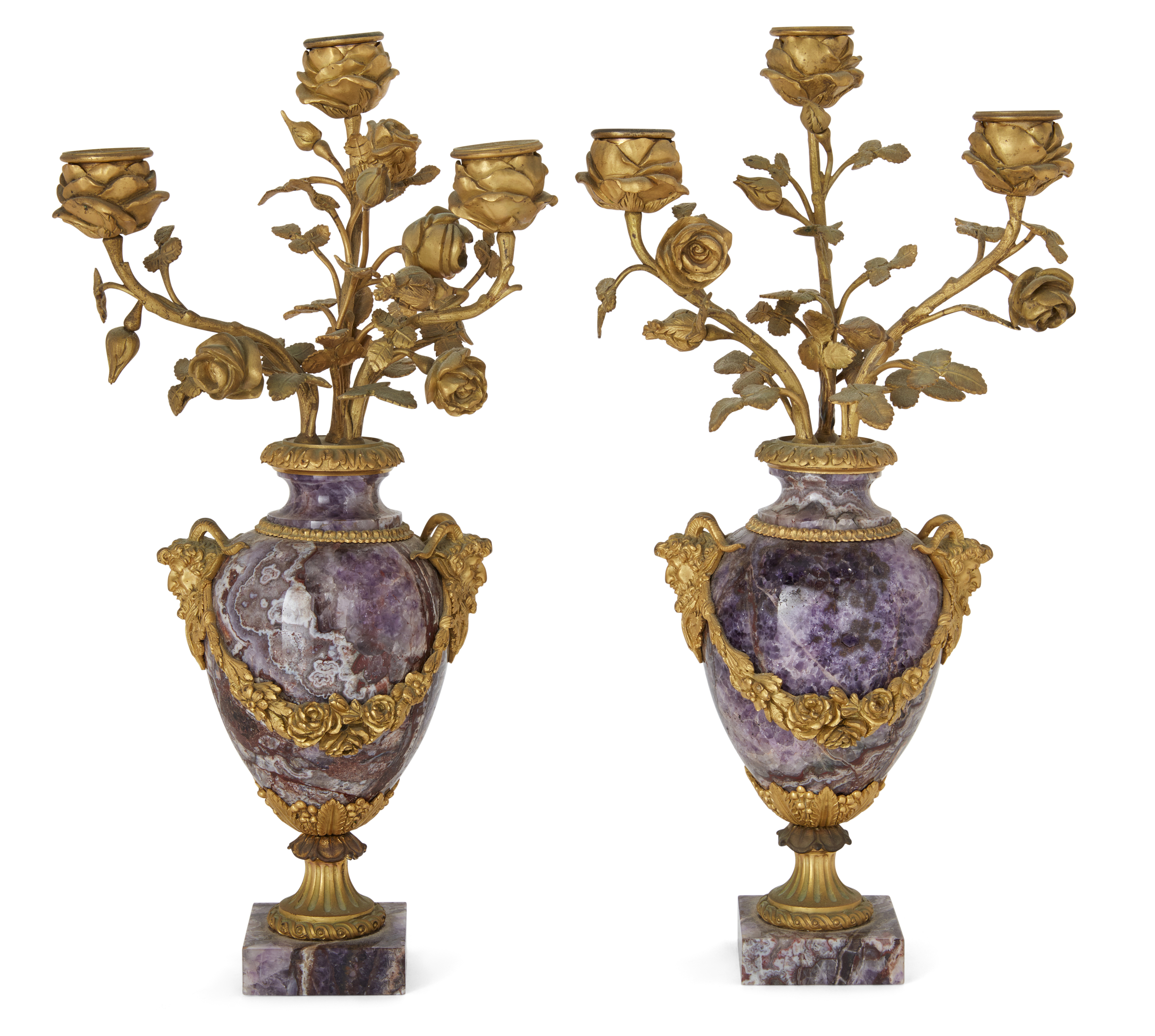 A pair of French gilt-bronze mounted amethyst three-light candelabra, Of Louis XVI style, mid-19t...