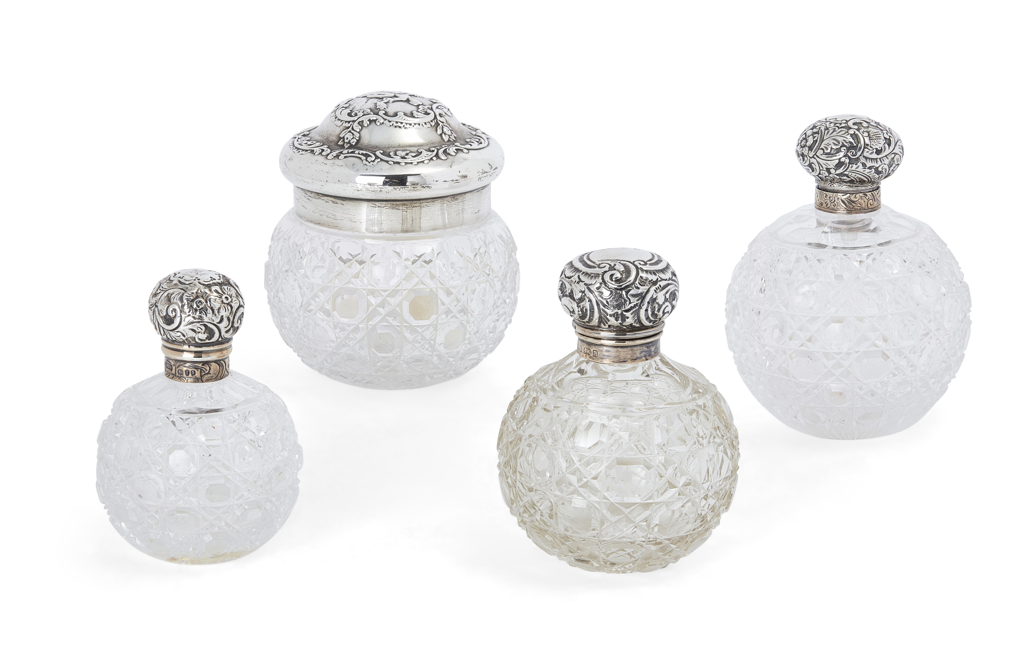 Three Victorian silver mounted cut glass scent bottles, Various dates and makers, Designed with g...