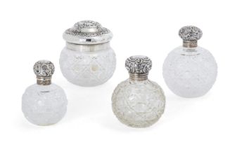 Three Victorian silver mounted cut glass scent bottles, Various dates and makers, Designed with g...