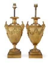 A pair of French gilt-bronze urn table lamps, Of Louis XVI style, late 19th century, Each with fr...