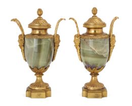 A pair of Louis XVI ormolu-mounted onyx urns and covers, Late 18th century, Each with berried fin...