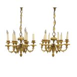 A pair of French gilt-bronze six-light chandeliers, Late 19th century, With stiff leaf surmount a...