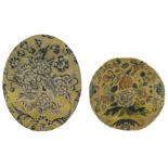 Two French oval needlework fragments, 18th century, Worked in wool, both with blossoming flowers ...