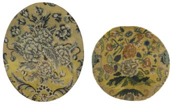 Two French oval needlework fragments, 18th century, Worked in wool, both with blossoming flowers ...