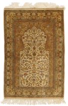 A Turkish silk Hereke prayer rug, Signed, third quarter 20th century,  The mihrab field with flor...