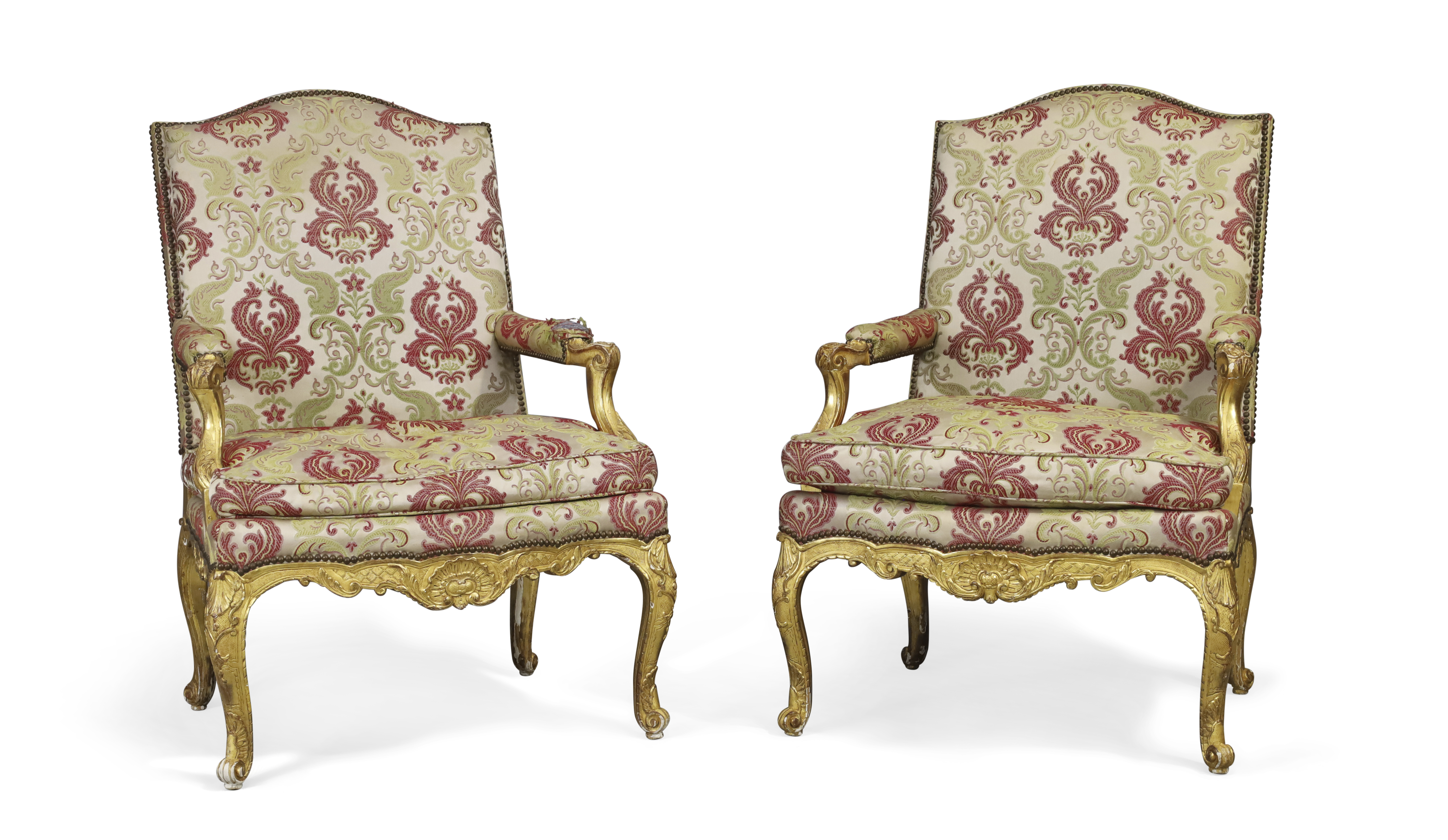 A pair of Regence giltwood fauteuils, First quarter 18th century, The frame carved with shells an...