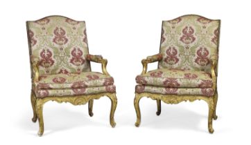 A pair of Regence giltwood fauteuils, First quarter 18th century, The frame carved with shells an...