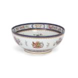 A French chinoiserie armorial punch bowl, Possibly Samson, mid-19th century, The heavily potted v...