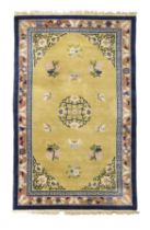 A Chinese wool carpet, Second quarter 20th century, Decorated with butterflies and floral sprays ...