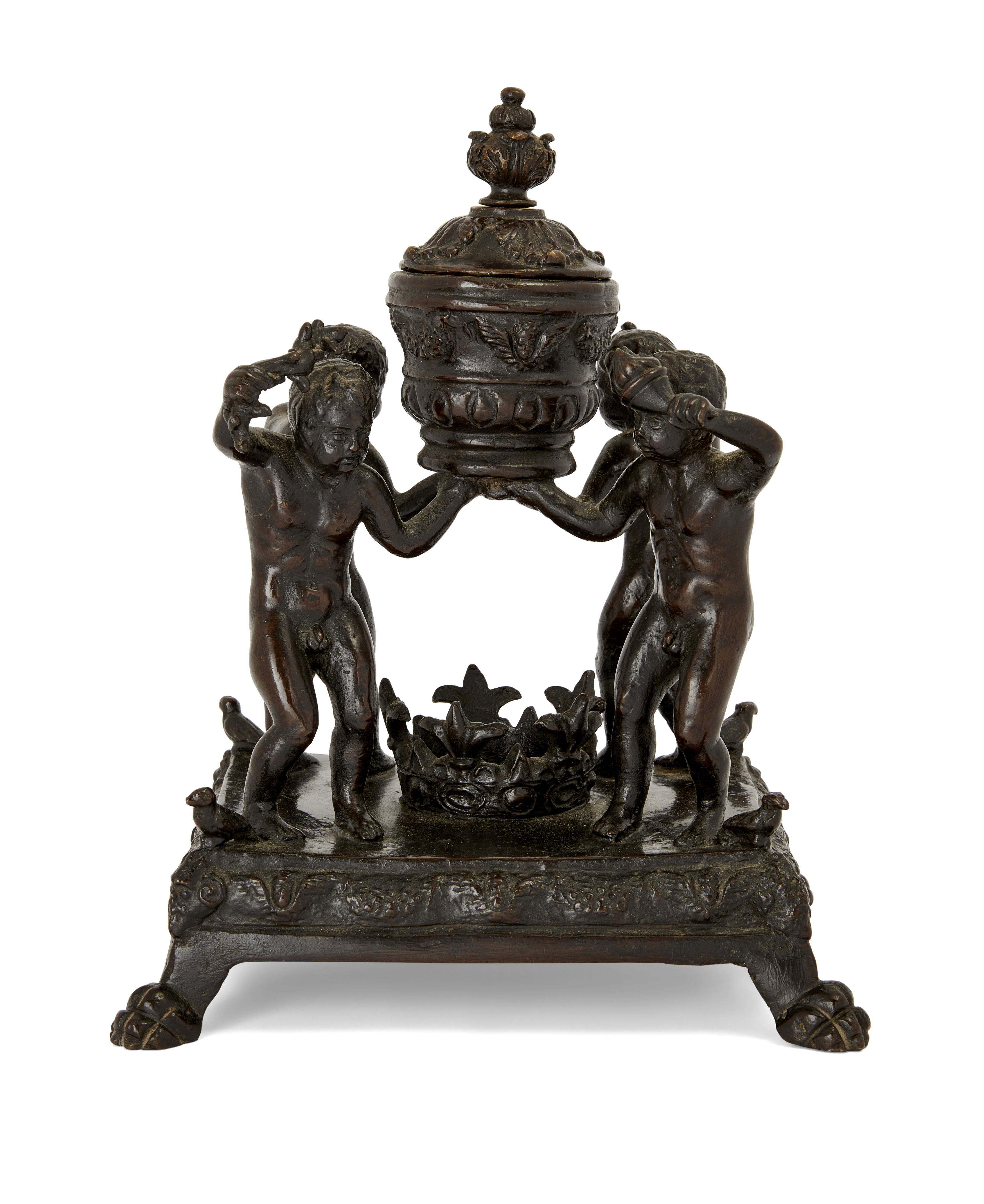 A Paduan bronze inkwell, 16th century, With four infants supporting a lidded vase, on a square se...