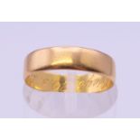 A 22 ct gold wedding band, inscribed to the inner band 'Always 20.3.65'. Ring size J/K. 2.7 grammes.