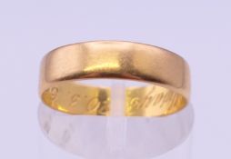 A 22 ct gold wedding band, inscribed to the inner band 'Always 20.3.65'. Ring size J/K. 2.7 grammes.