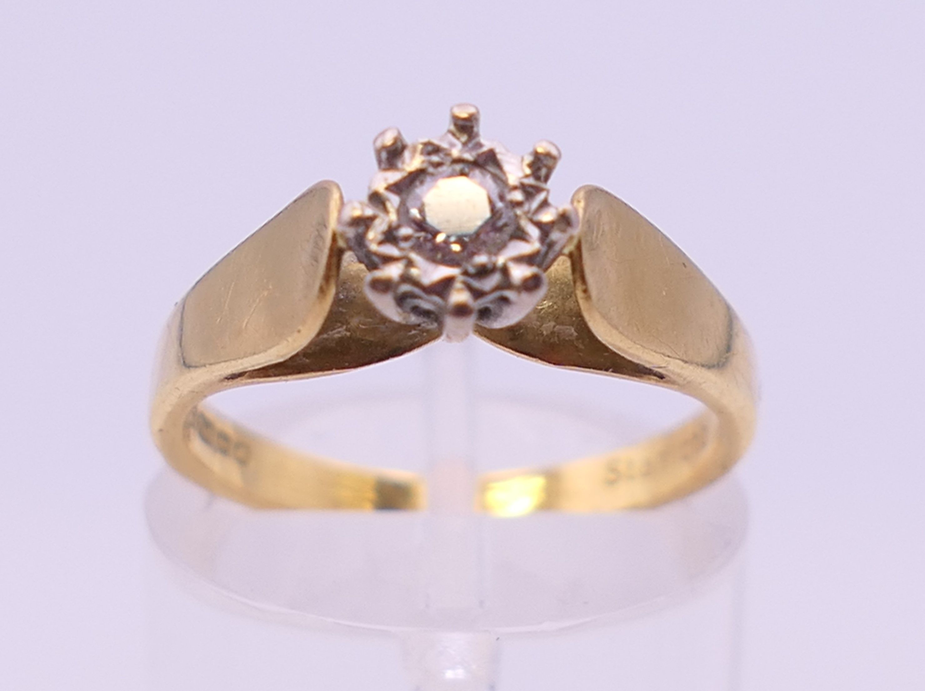 An 18 ct gold diamond solitaire ring. Ring size L/M.