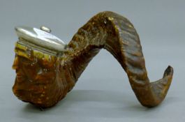 A 19th century carved horn table snuff mull with unmarked white metal lid. 23 cm long.