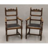 A pair of carved oak open armchairs. Each 57.5 cm wide.