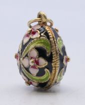 A silver enamel egg pendant. 2.5 cm high.