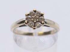 An 18 ct gold diamond set cluster ring. Ring size P.