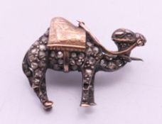An unmarked silver and gold old rose cut diamonds camel form brooch. 2.5 cm long.