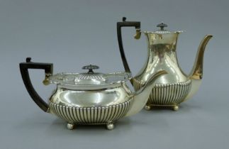 A stop gadrooned silver teapot and matching coffee pot. The latter 21.5 cm high. 1418.