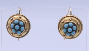 A pair of 9 ct gold and turquoise earrings. 1.2 cm diameter.