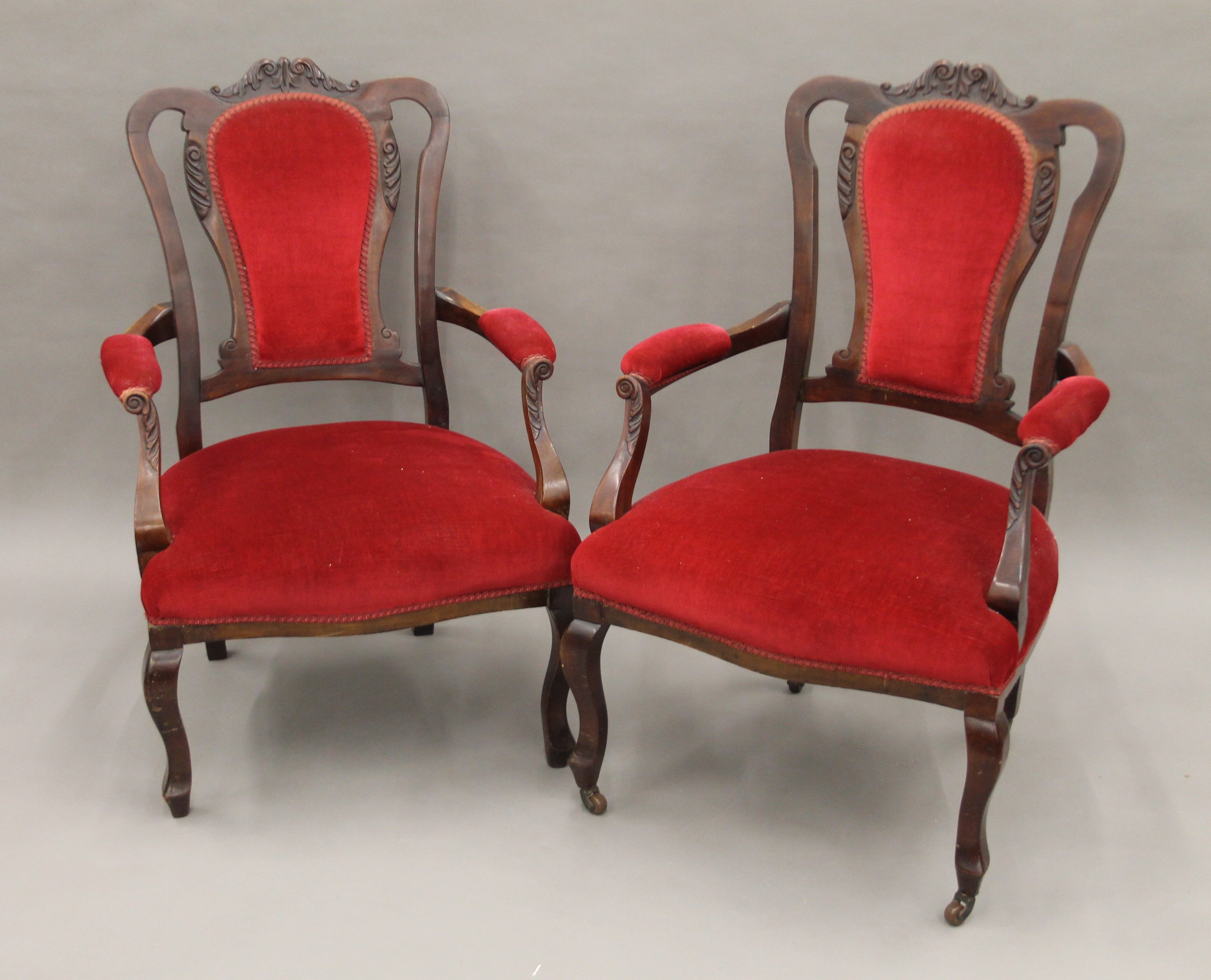 A pair of Edwardian upholstered mahogany salon open armchairs. The largest 66 cm wide.