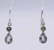 A pair of silver drop earrings. 2 cm high.