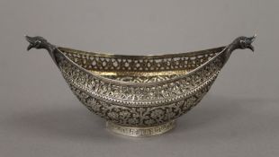 A Persian/Kashmiri unmarked silver kovsh with pierced and chased decoration. 15 cm wide. 110.