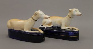 A pair of 19th century Staffordshire pottery light faun greyhounds wearing coursing collars,
