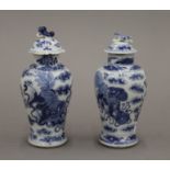 Two small 19th century Chinese blue and white porcelain lidded vases. Each approximately 14.