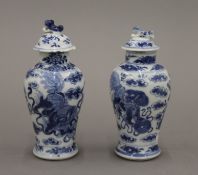 Two small 19th century Chinese blue and white porcelain lidded vases. Each approximately 14.