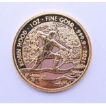 A 2021 Robin Hood 1oz fine gold 100 pound coin. 31.2 grammes.