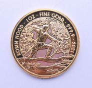 A 2021 Robin Hood 1oz fine gold 100 pound coin. 31.2 grammes.