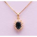 An 18 ct gold pendant on a chain. The pendant 1.2 cm high. 3.7 grammes total weight.