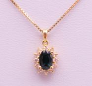 An 18 ct gold pendant on a chain. The pendant 1.2 cm high. 3.7 grammes total weight.