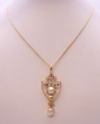 A 9 ct gold pearl pendant on an Edwardian 9 ct gold chain. The pendant 4 cm high. 4.