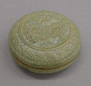 A Chinese celadon box. 9 cm diameter.