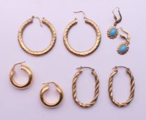 Four pairs of yellow metal earrings. The largest 3.5 cm diameter.