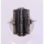 An Art Deco style silver, onyx and marcasite ring.