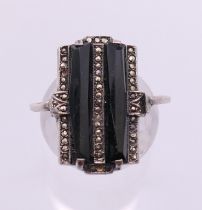 An Art Deco style silver, onyx and marcasite ring.