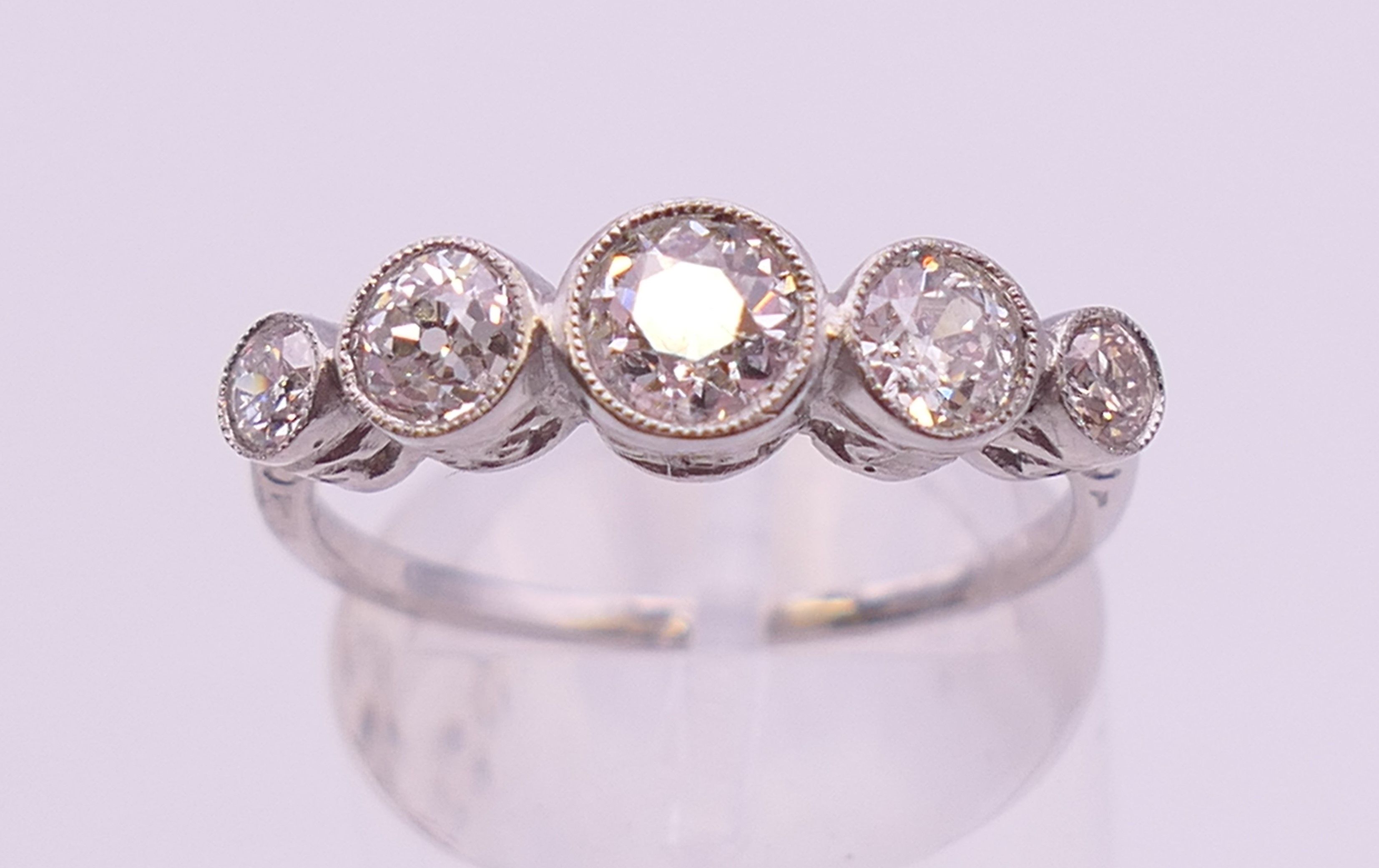 A platinum five stone diamond ring. Ring size N/O. - Image 2 of 6