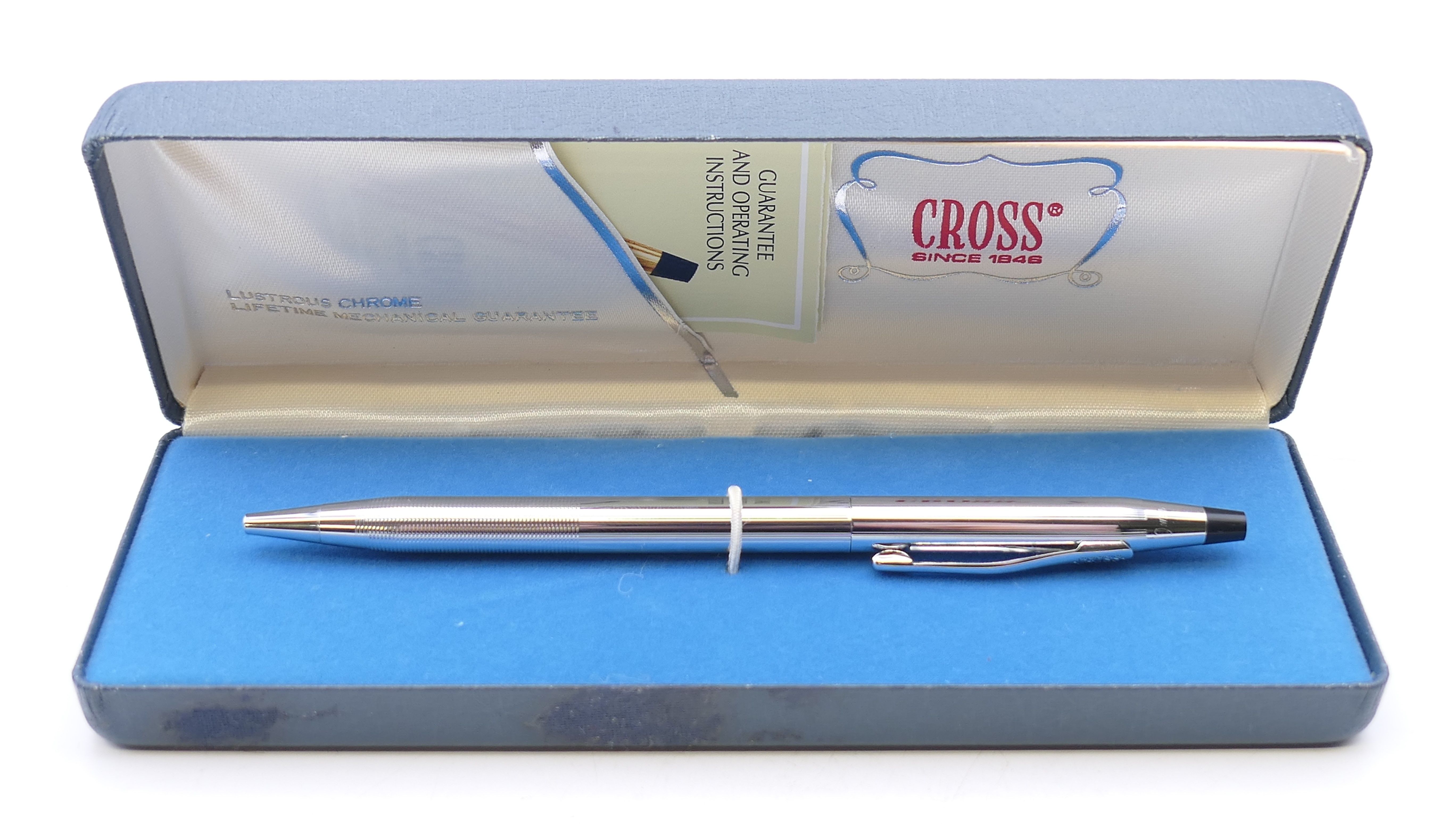 A boxed Cross ballpoint pen.