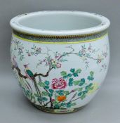 A 19th century Chinese famille vert porcelain fish bowl, painted with birds and flowers.