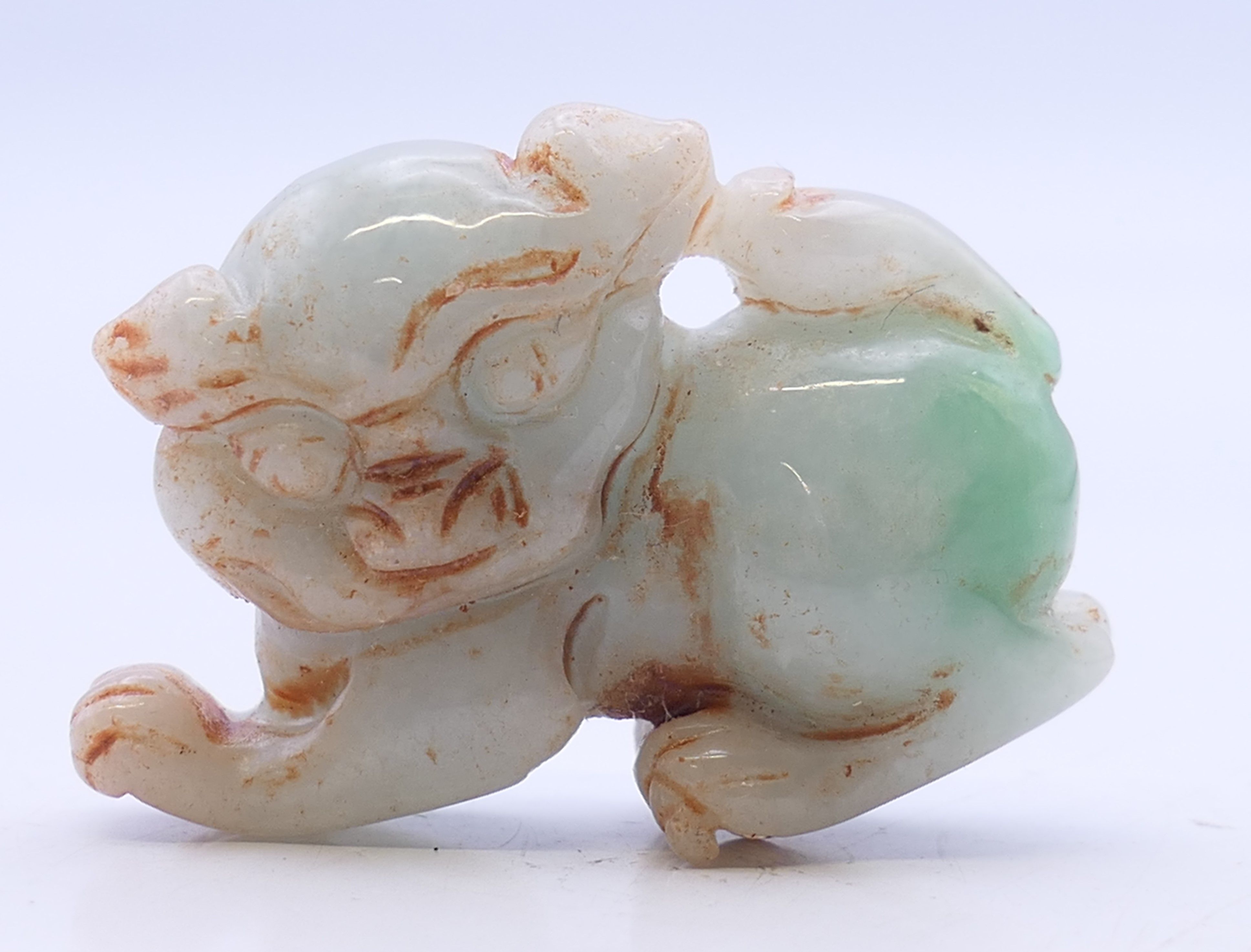A small jade dog-of-fo. 4 cm long.