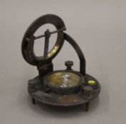 A boxed brass sundial compass. The box 12.5 cm wide.