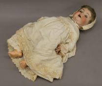 A 19th century German bisque headed doll. 58 cm high.