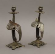 A pair of candlesticks formed from sword handles. 27 cm high.