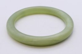 A celadon jade bangle. Approximately 5.5 cm internal diameter.